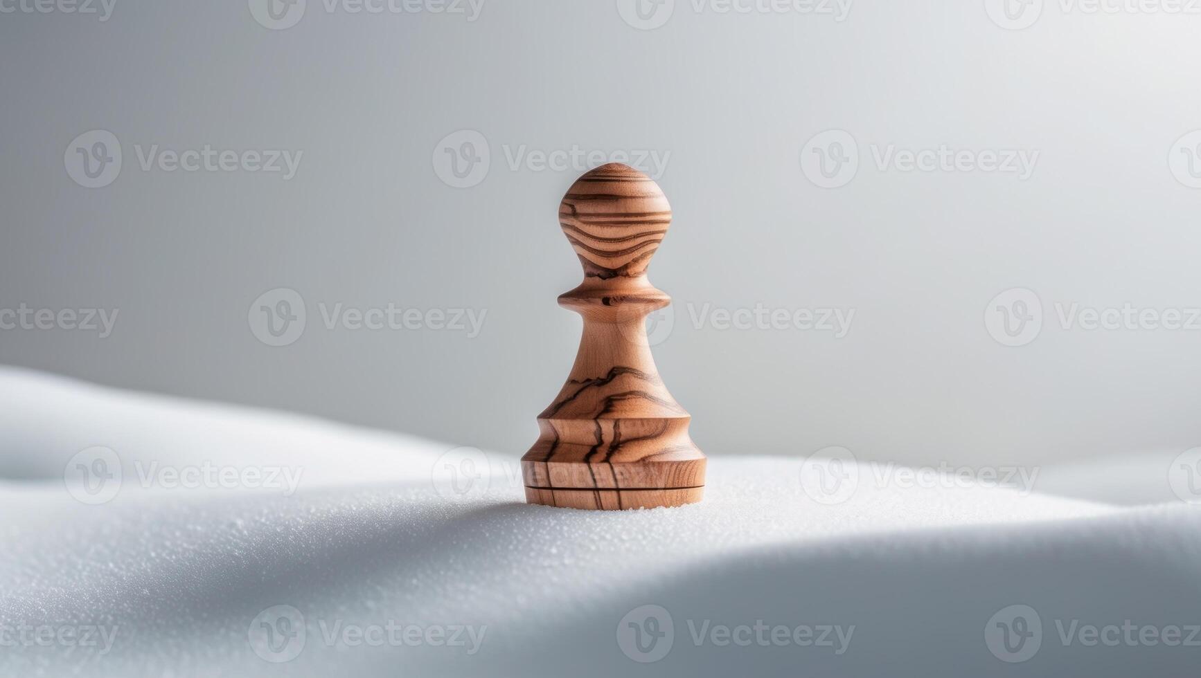A wooden chess piece sitting on top of snow photo