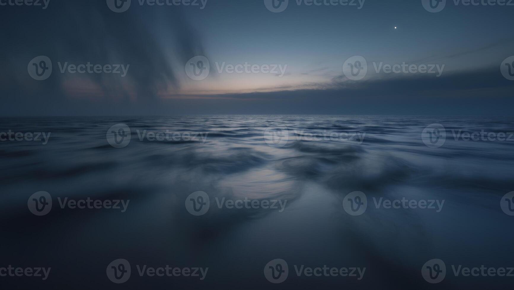 A long exposure photograph of the ocean at dusk photo