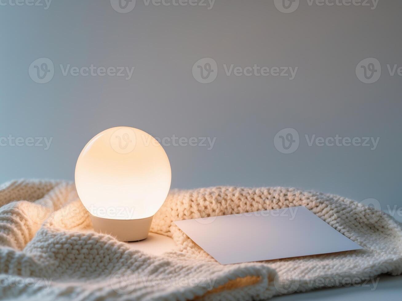 A lamp and a card on a table photo