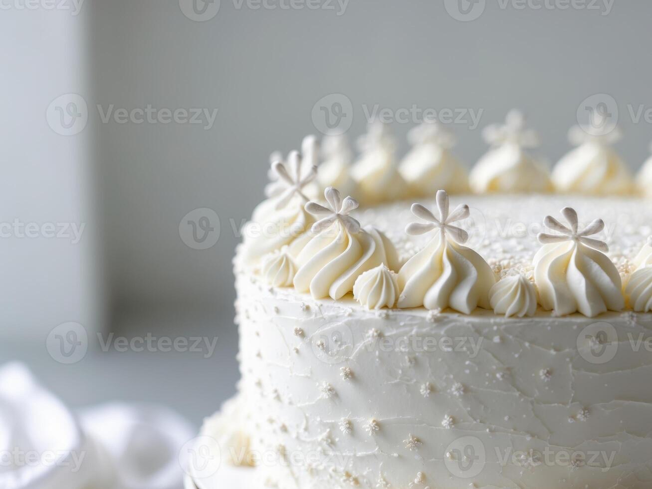 A white frosted cake with white frosting on top photo