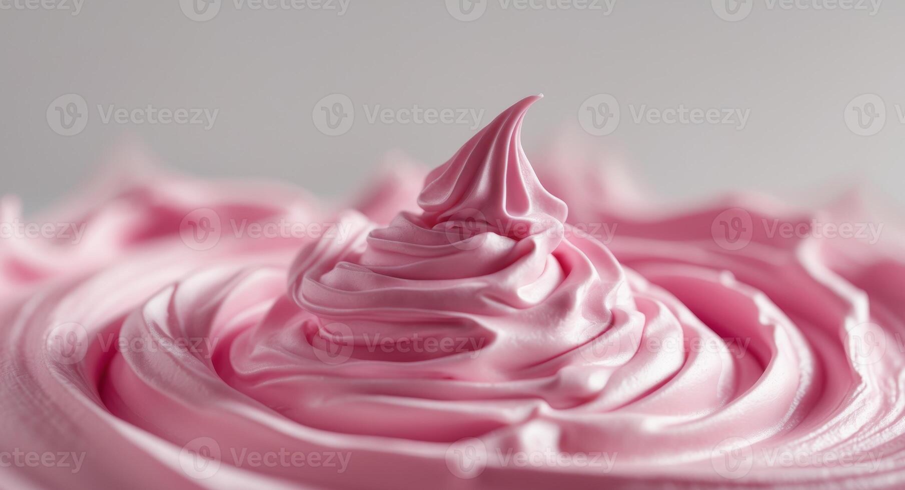 A close up of a pink frosting on top of a cake photo