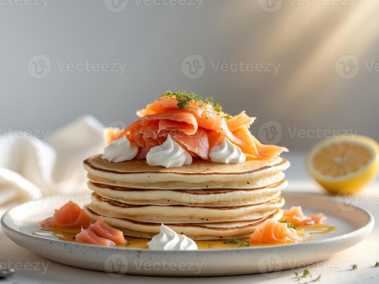 Stack of Pancakes Topped with Smoked Salmon and Cream Cheese, Served with Lemon. photo