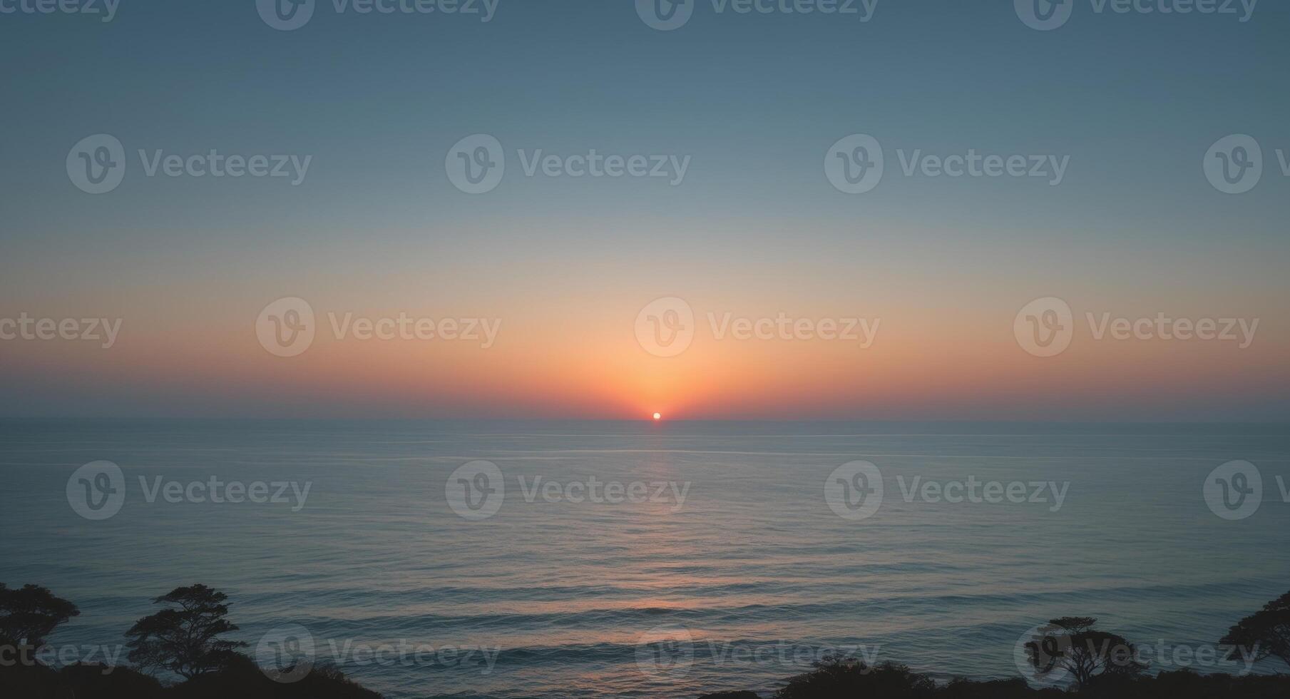 Ocean Serenity. A Peaceful Sunset Over Calm Waters, Framed by Silhouetted Trees photo