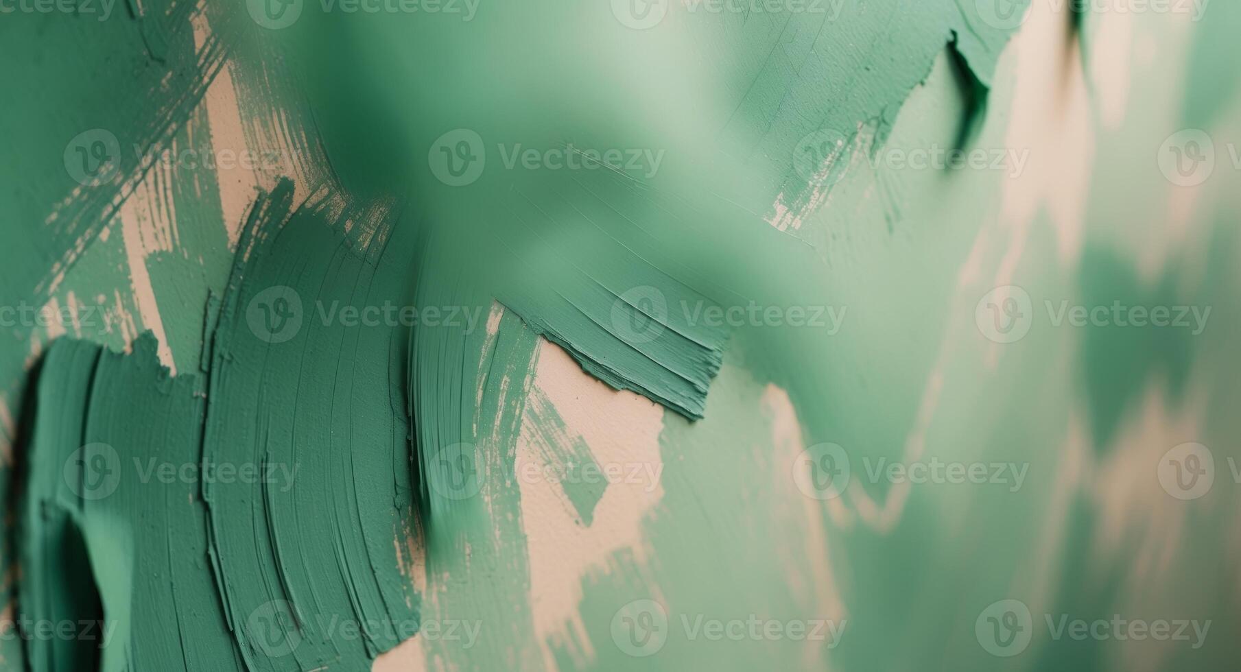 A green paint brush is being used to paint a wall photo