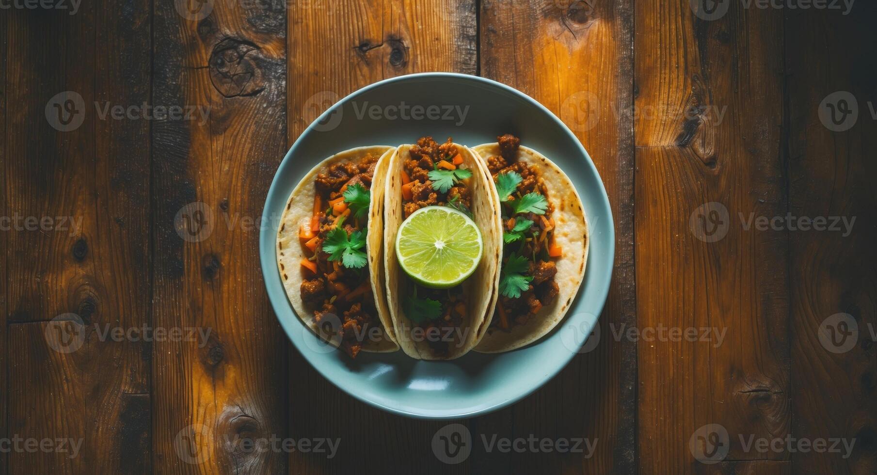 Tacos on a Plate with Lime and Cilantro, Served on a Rustic Wooden Table. photo