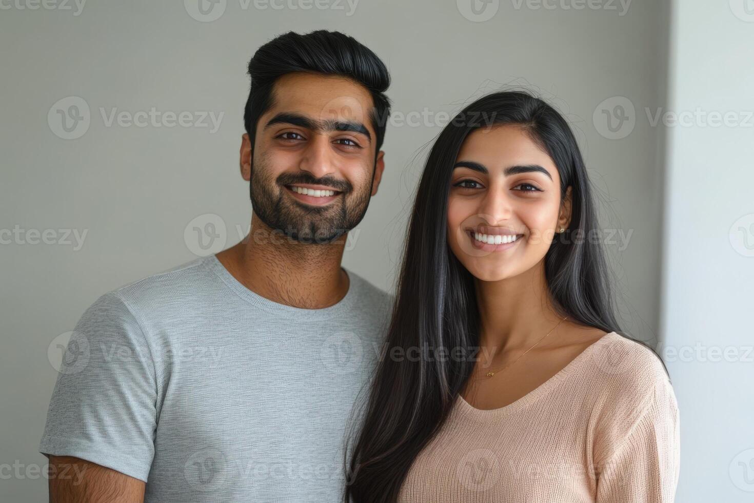 A young couple smiling and posing for the camera. photo