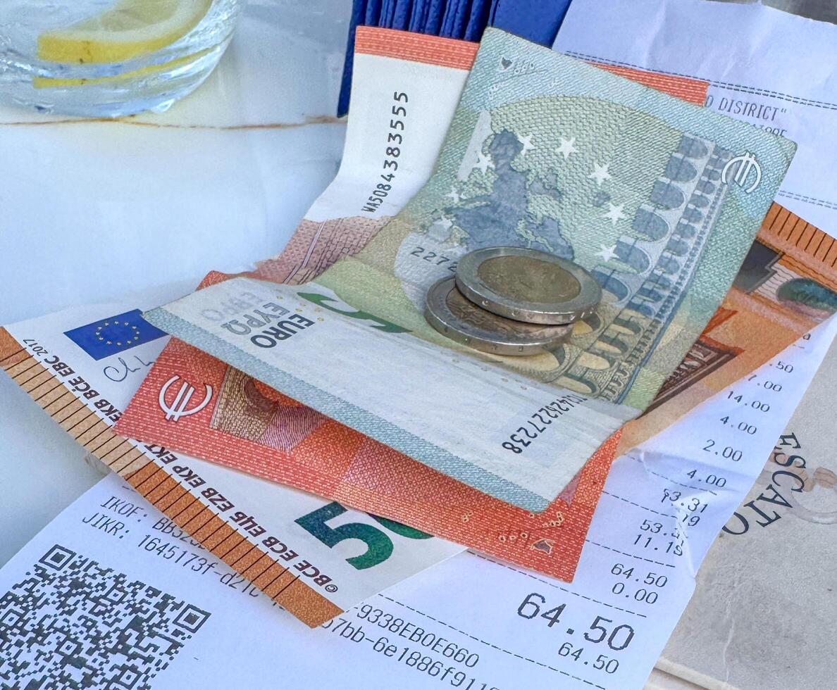 Tivat, Montenegro - April 25, 2025. a check with money on the table at Il Pescatore cafe,Marina Porto Montenegro photo