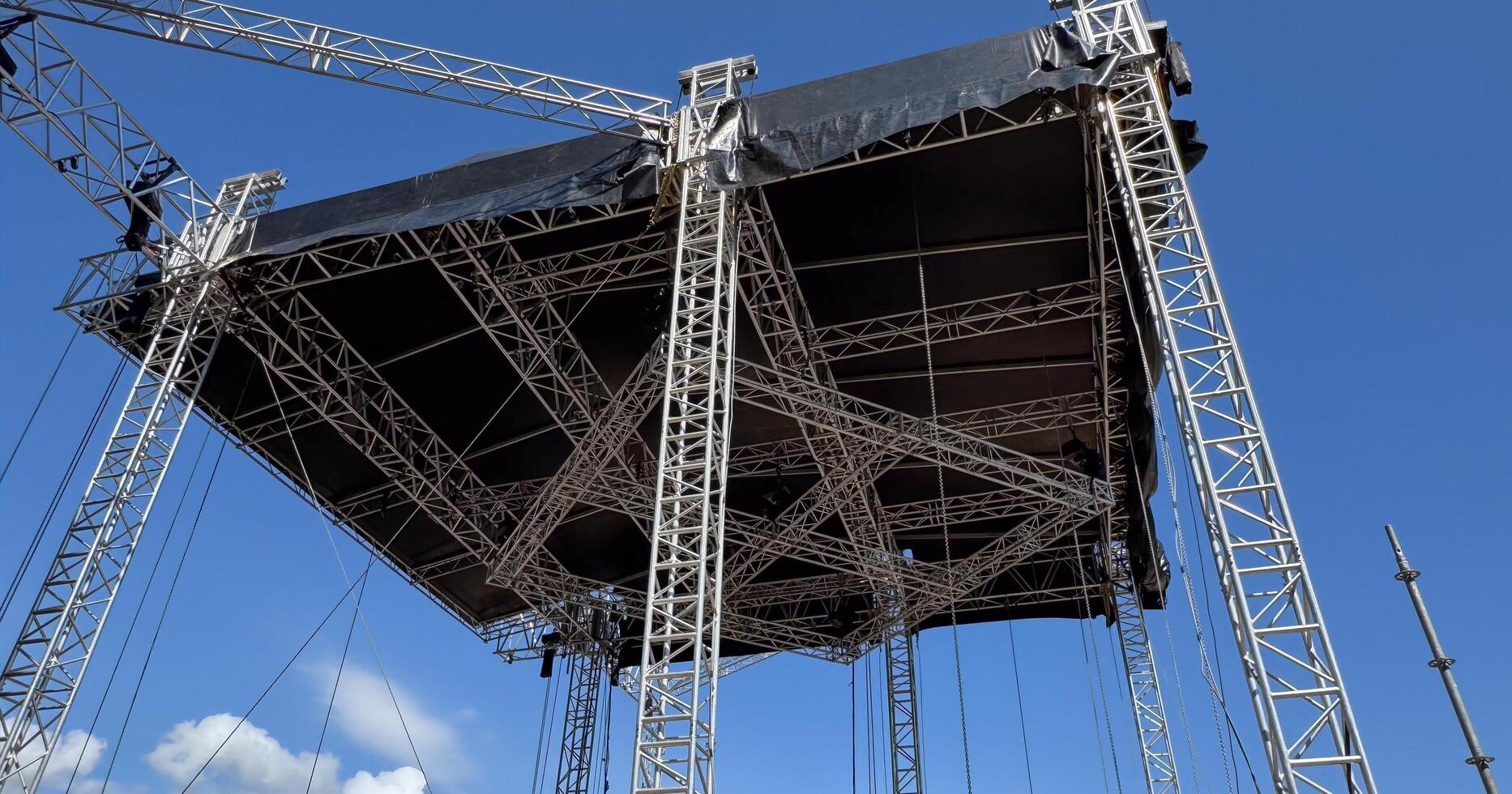 Budva, Montenegro - May 18, 2025. Stage structure being built for Montenegro Independence Day festivities with blue sky backdrop photo