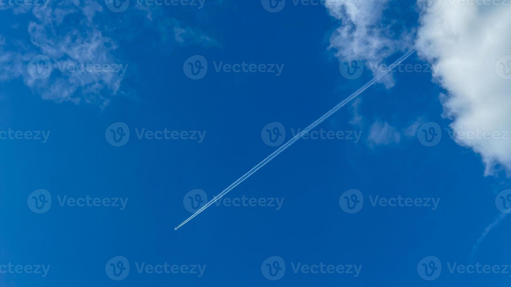 A sleek jet stream carves through azure skies, epitomizing the wanderlust of International Aviation Day and Sky Awareness Week photo