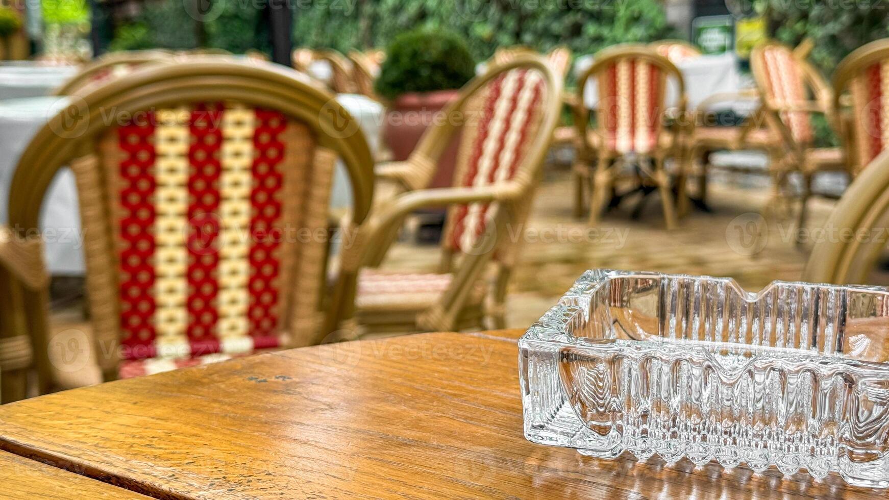 Empty vintage cafe terrace, wicker chairs whisper stories, awaiting La Tomatinas vibrant chaos or quiet Yule reflections photo