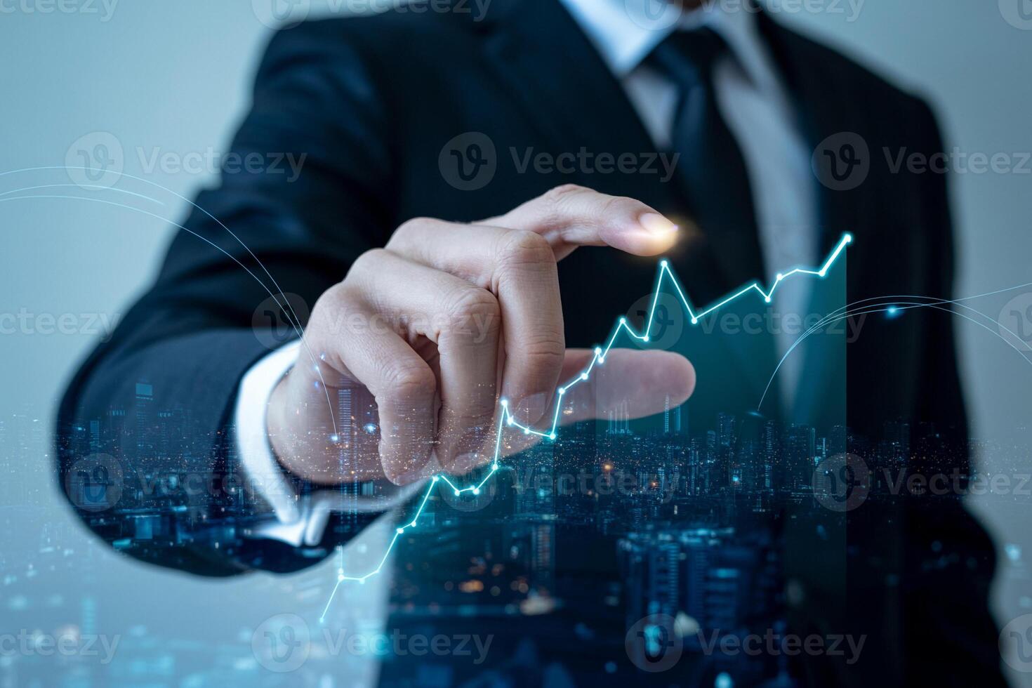 Businessman pointing at a graph on a screen photo