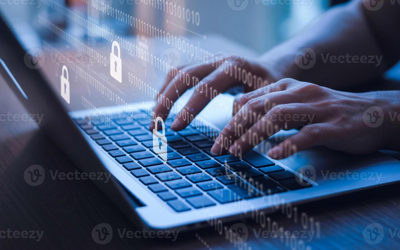 A person typing on a laptop with a padlock icon photo