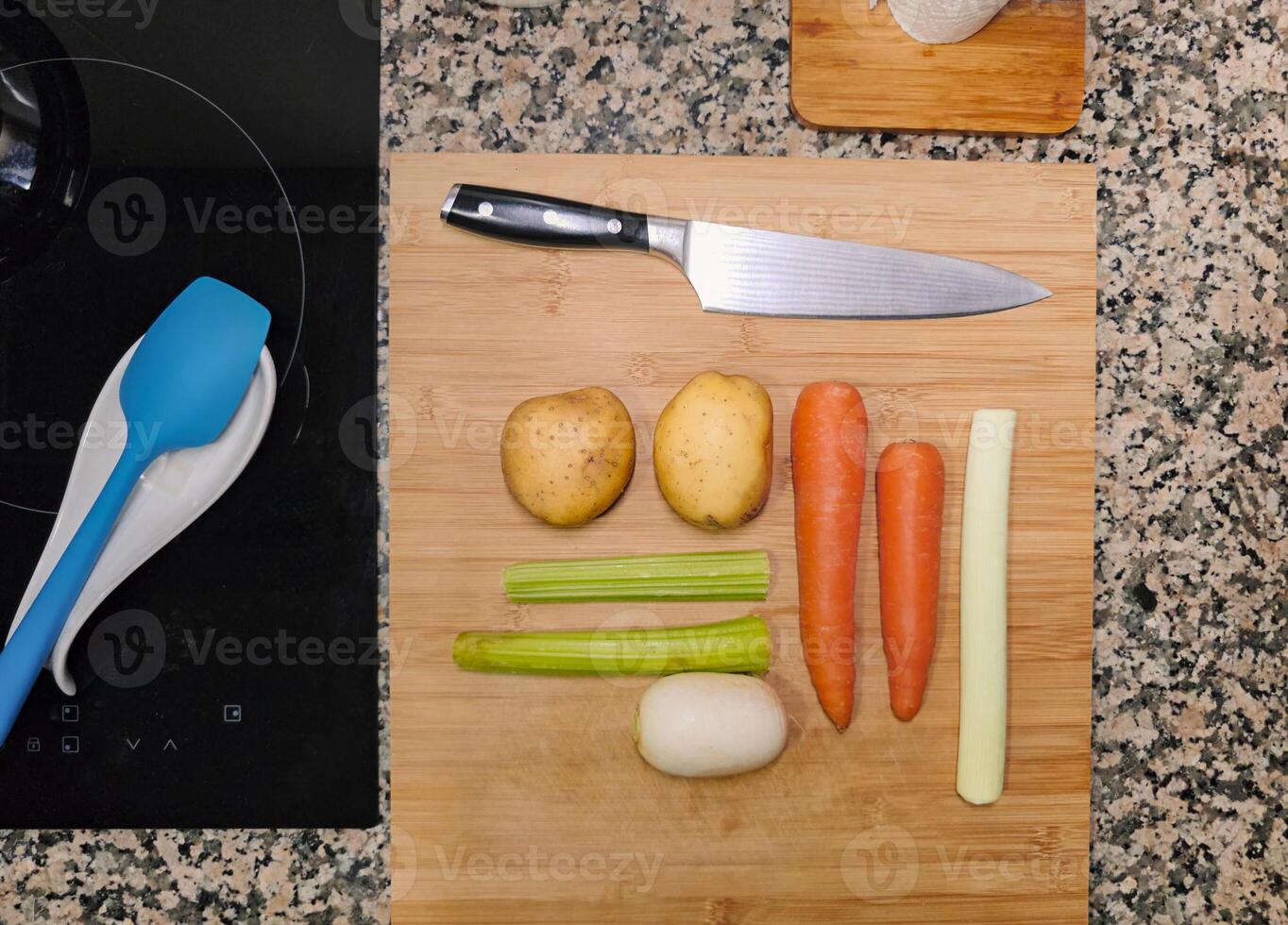 Top view of wood cutting board with vegetables and knife. Homemade food kitchen. photo
