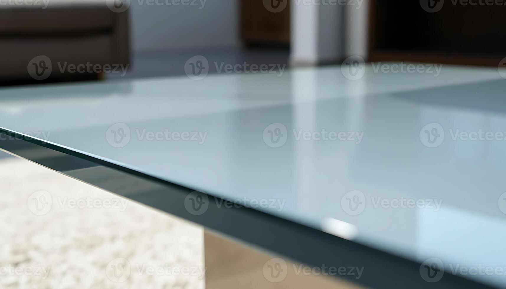 close up of a glass table with a couch in the background photo