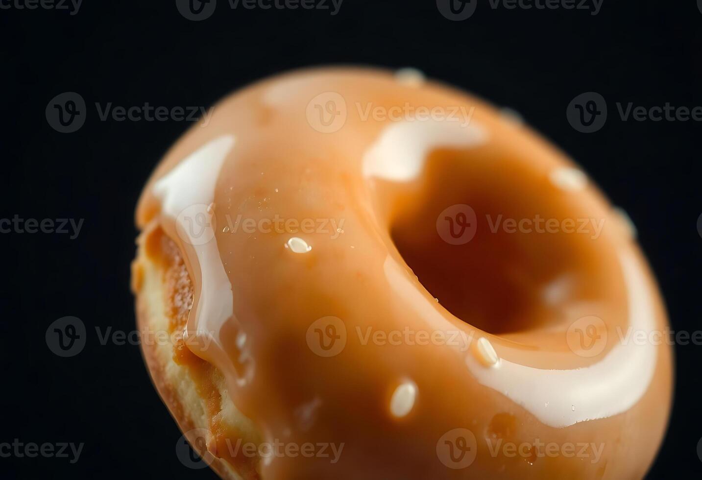 close up of a glazed donut with icing photo