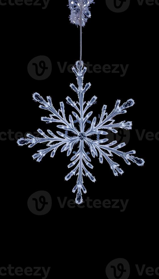 snowflake hanging from a black background photo