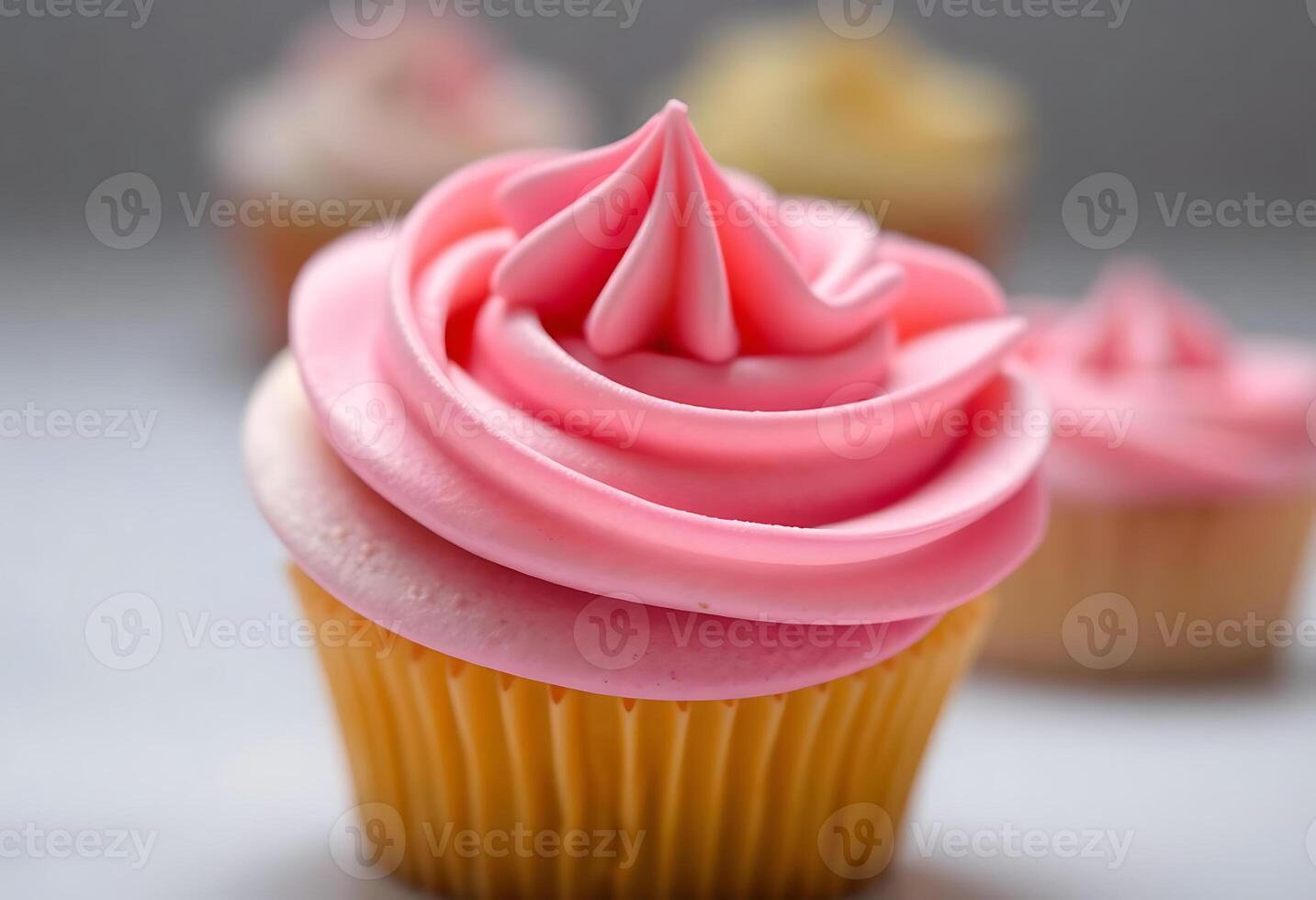close up of a cupcake with pink frosting photo