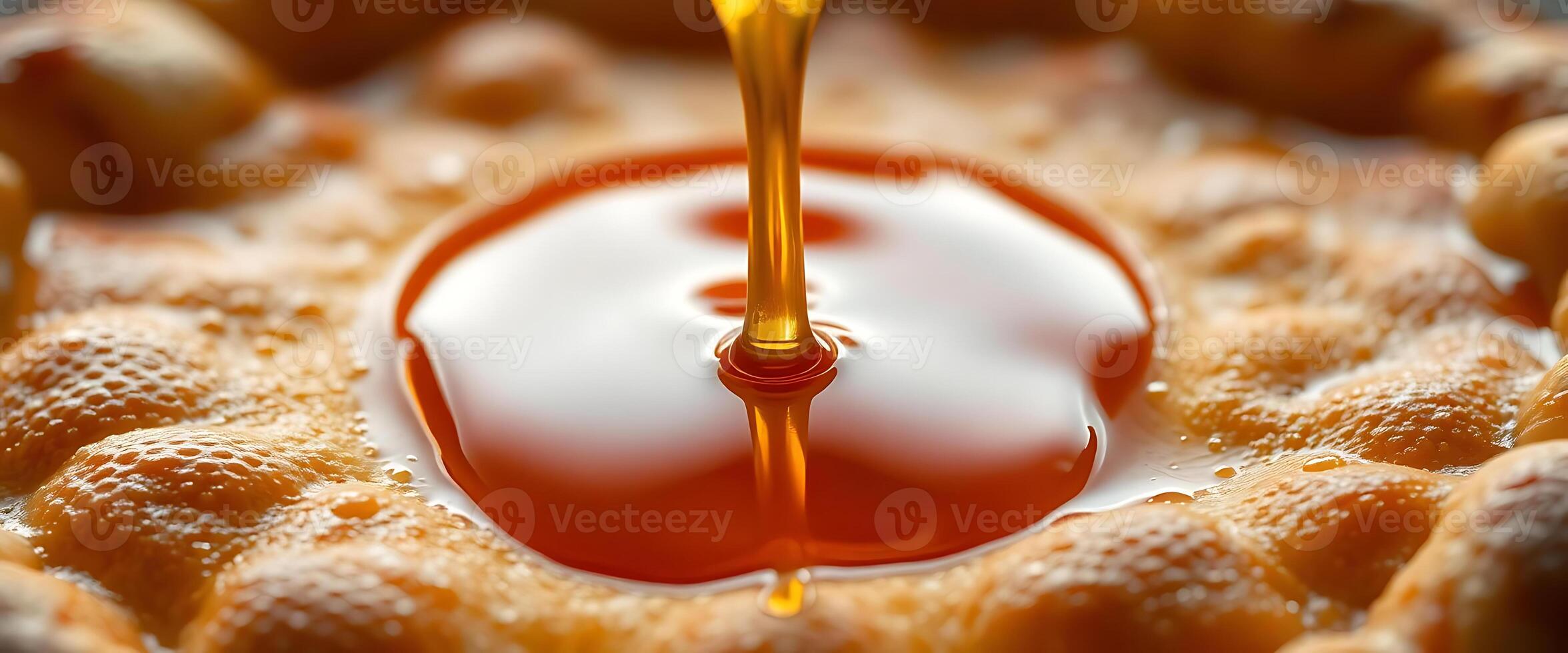 spoon is dripping sauce on a pastry photo