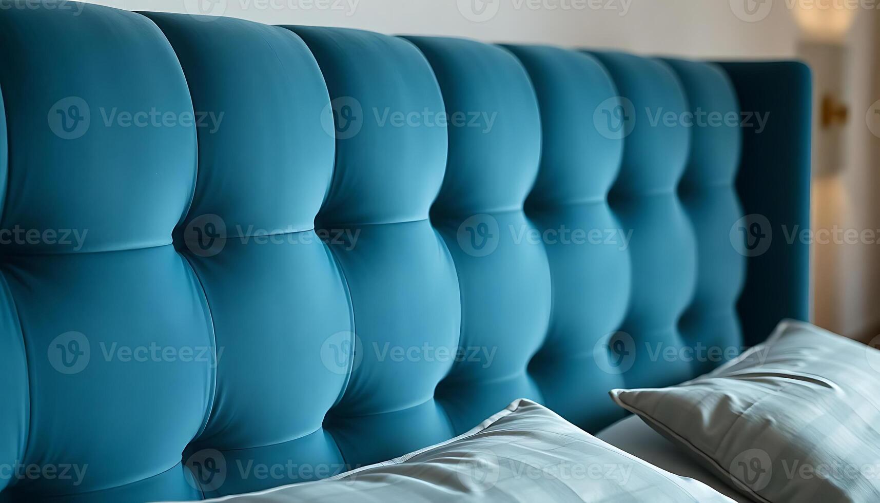 close up of a bed with a blue headboard photo