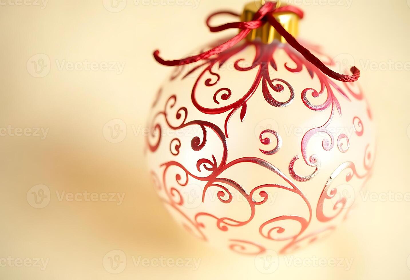 red and white ornament with a red ribbon photo