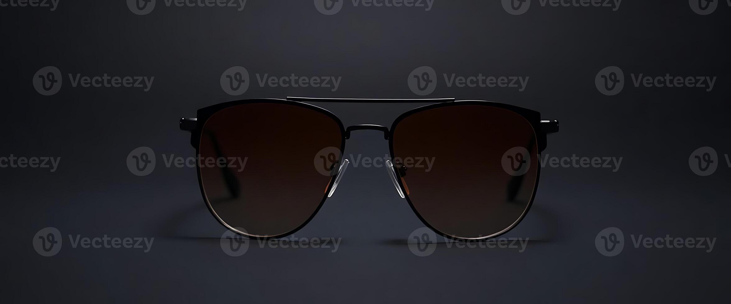 pair of sunglasses on a dark background photo