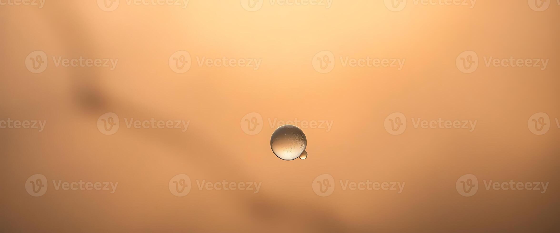 drop of water sitting on top of a brown surface photo
