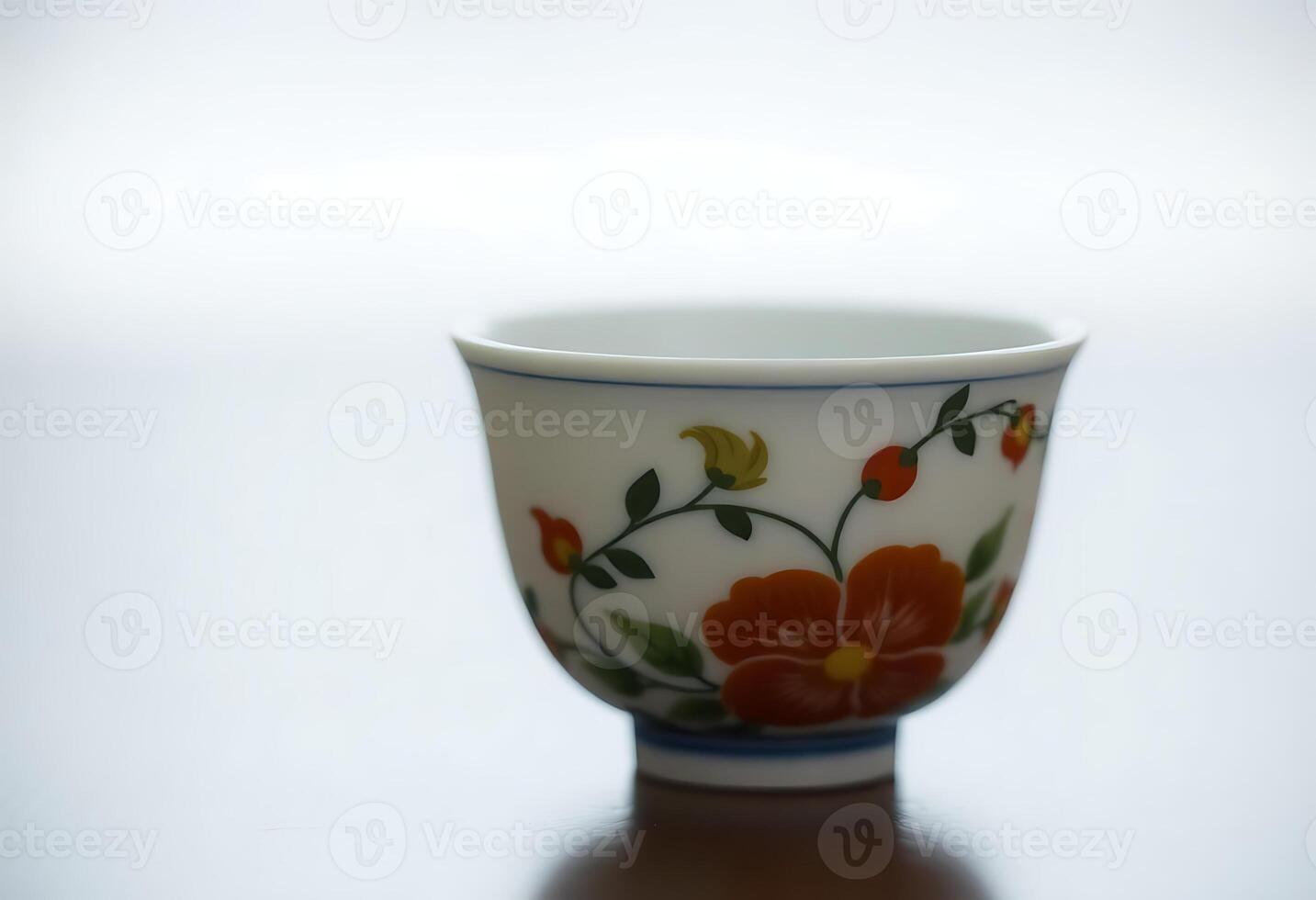 white and blue cup with flowers on it photo
