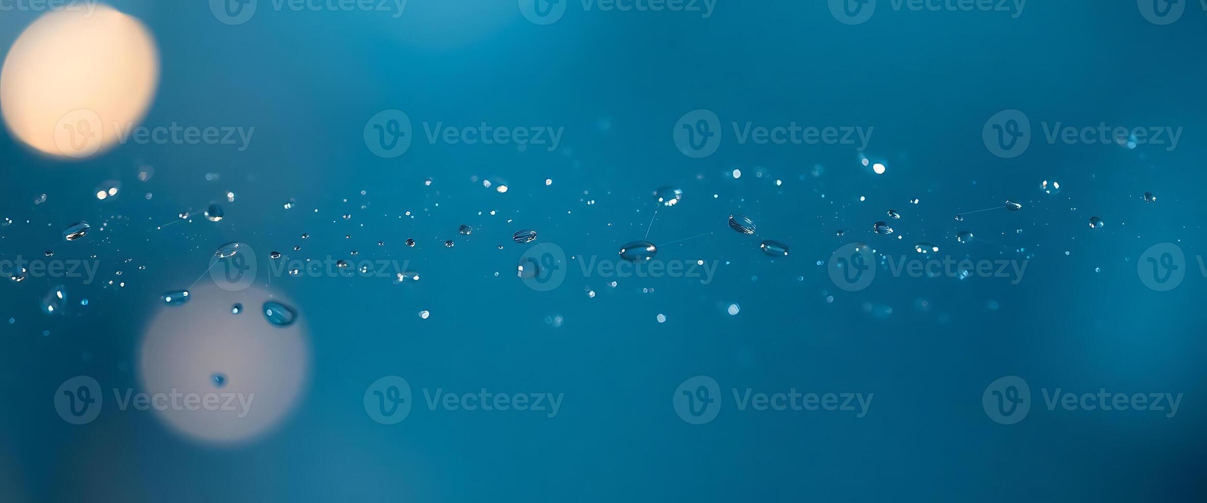 close up of water droplets on a blue surface photo