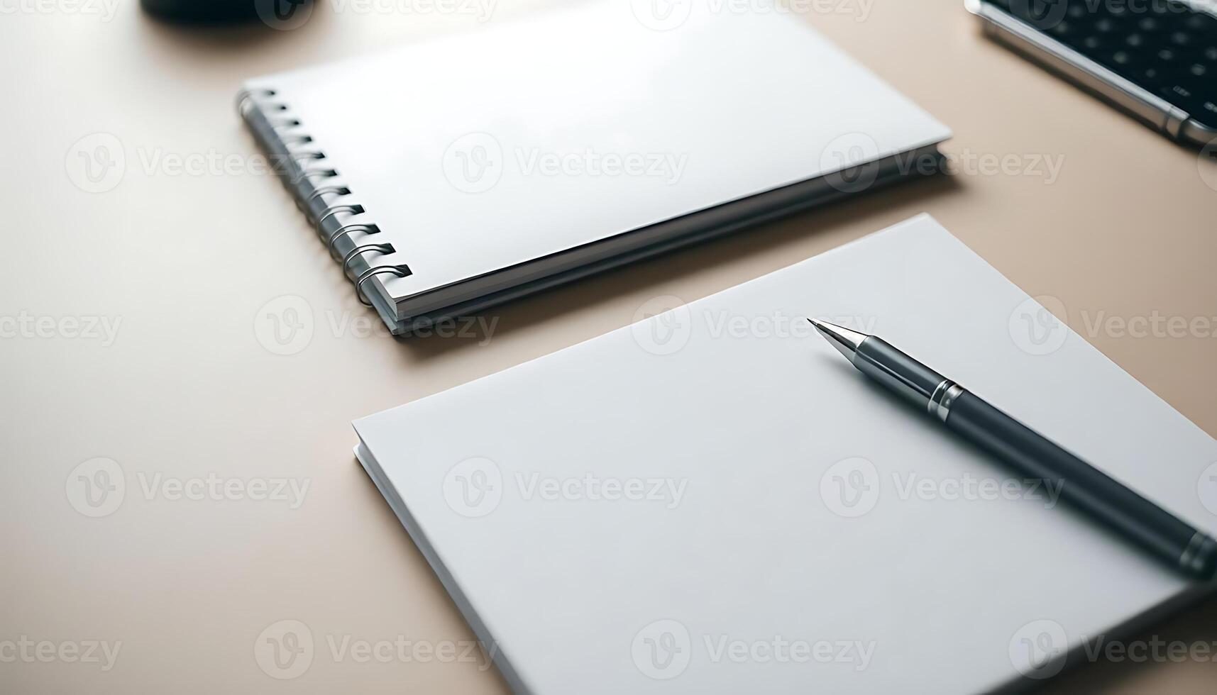 two notebooks and a pen on a table photo