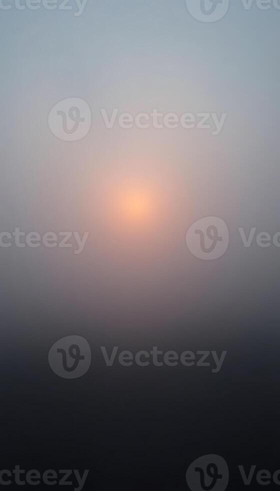 foggy sky with the sun in the distance photo