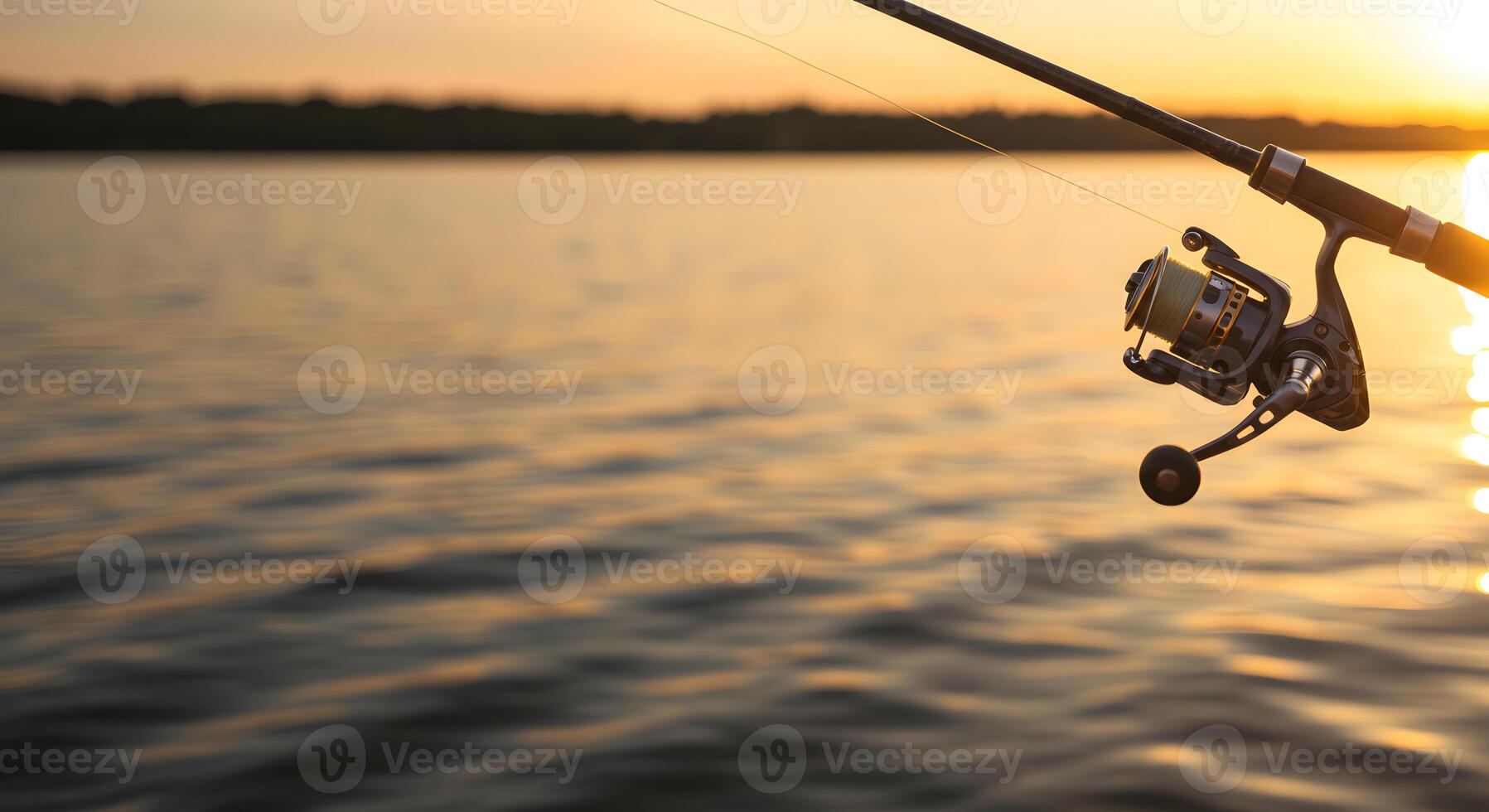 A fishing rod and reel on the shore of a lake photo