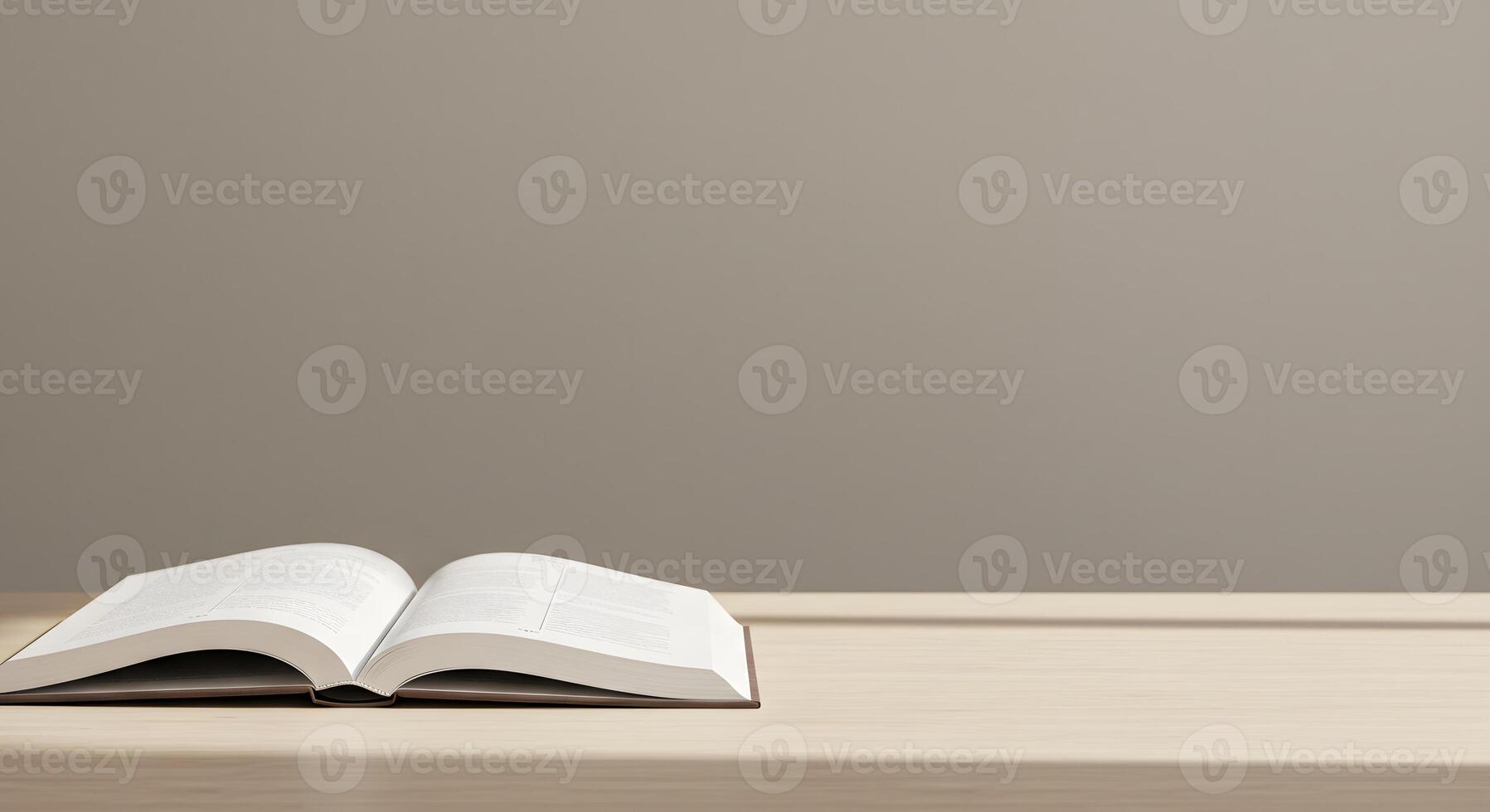 An open book is sitting on a table in front of a wall photo