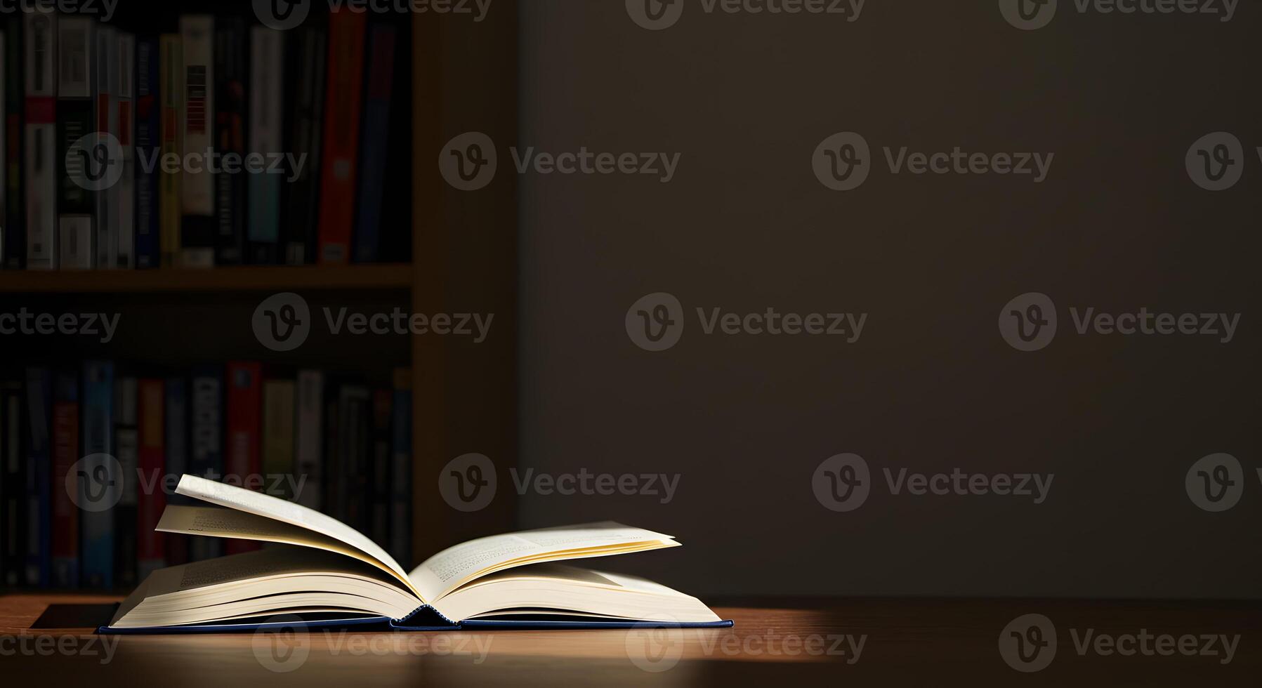 An open book on a table in front of a book shelf photo