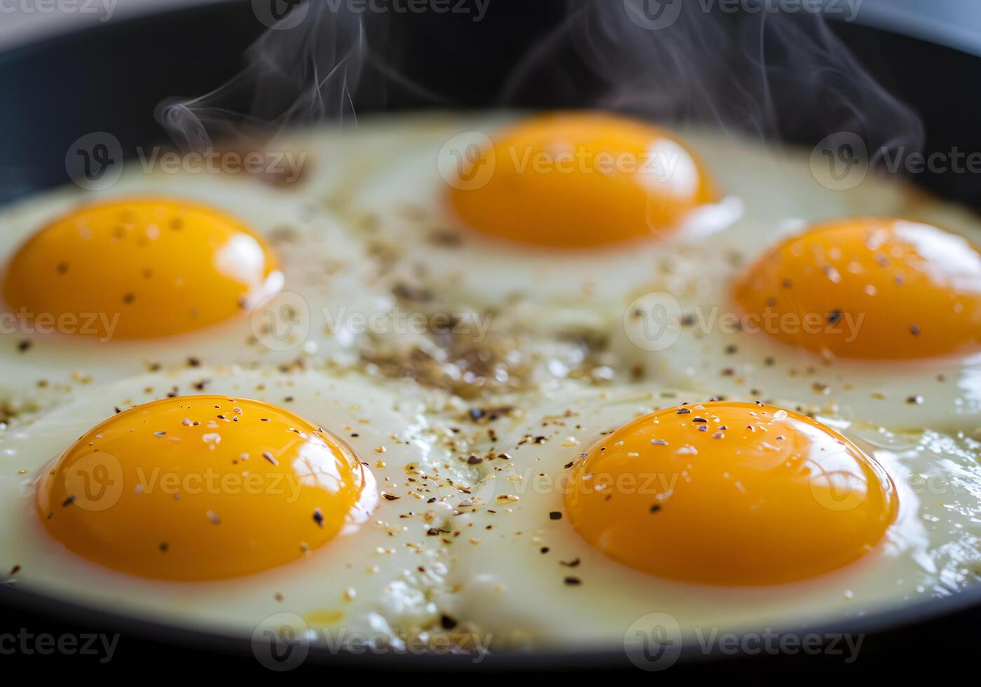 Four eggs are cooking in a frying pan photo