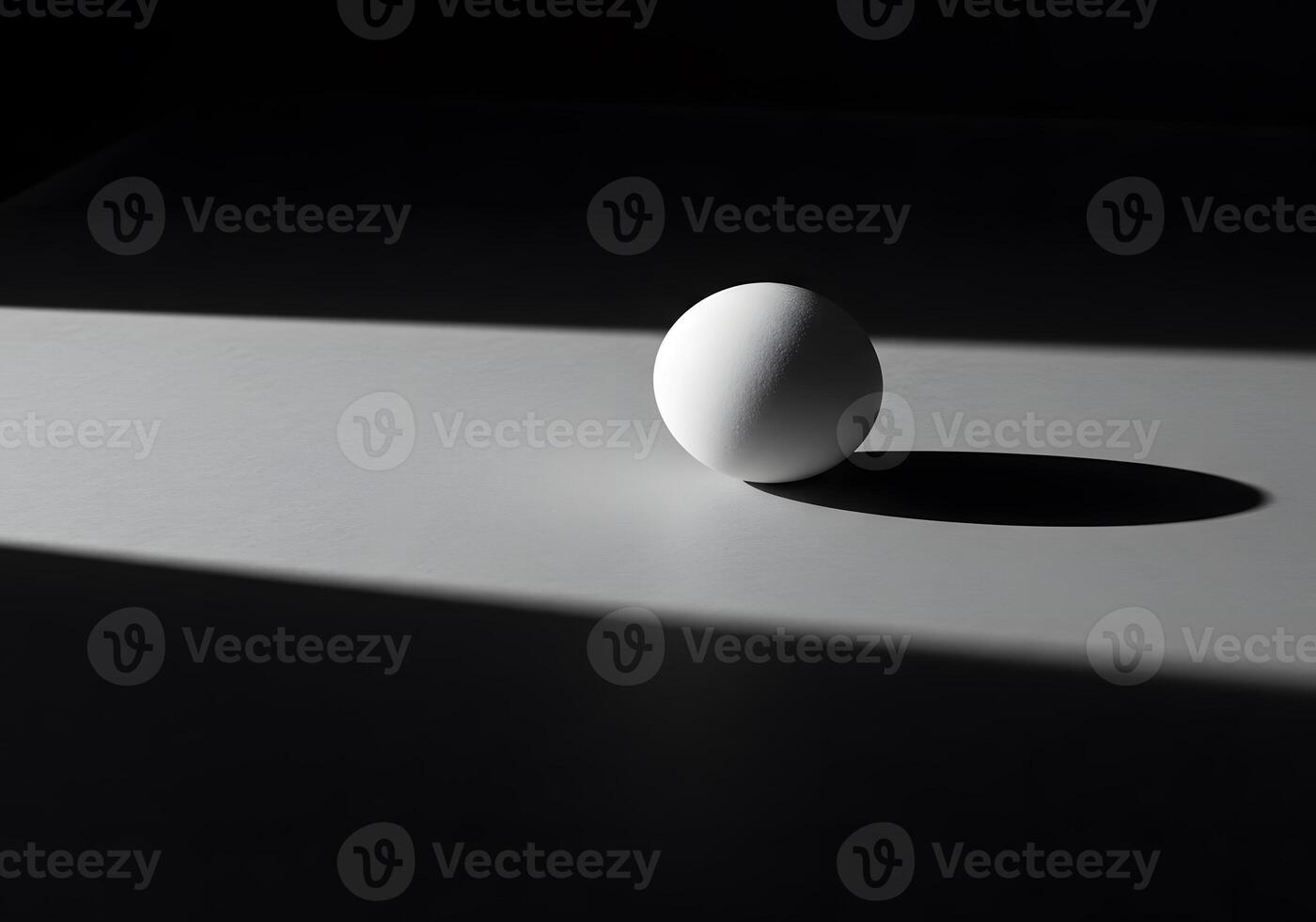 An egg sitting on a table with the light shining on it photo