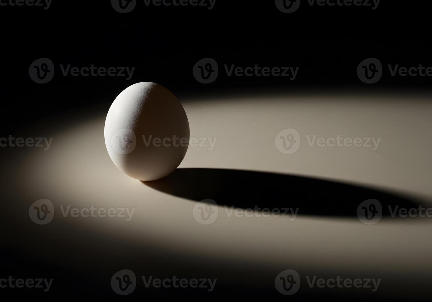 An egg is sitting on a table with a shadow photo