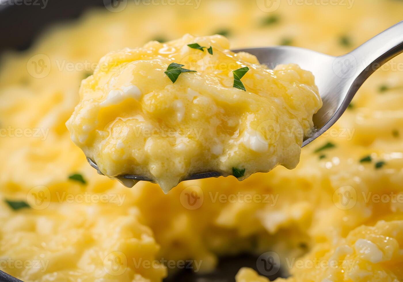 A spoon with a spoonful of scrambled eggs photo