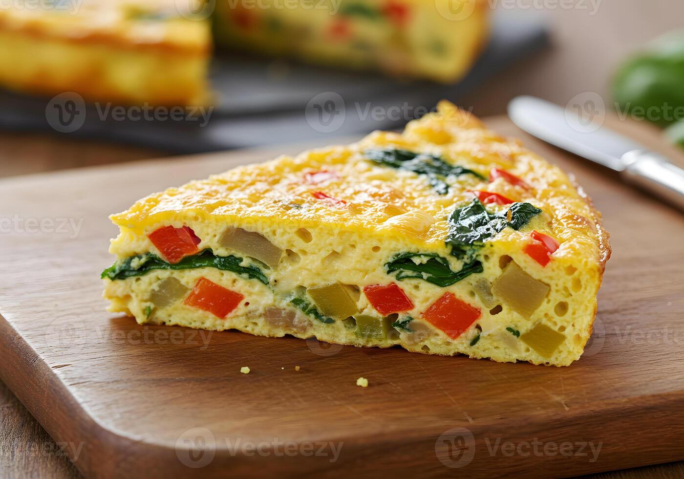 A slice of quiche on a cutting board photo