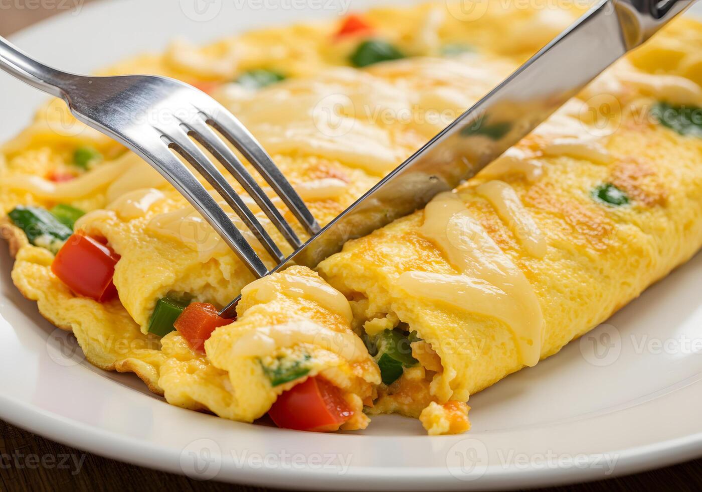 A plate with a fork and a breakfast omelet photo