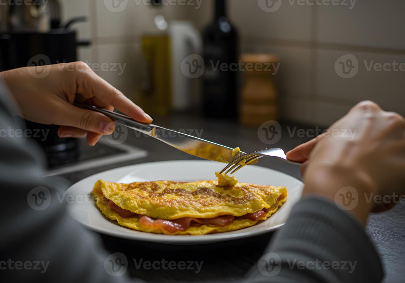 A person is eating an omelet with a fork photo