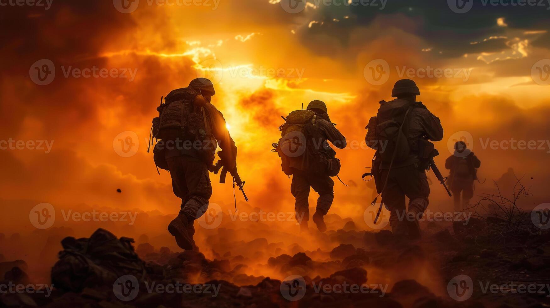 Silhouetted soldiers advance in a fiery war zone under a dramatic, orange-tinted sunset. photo