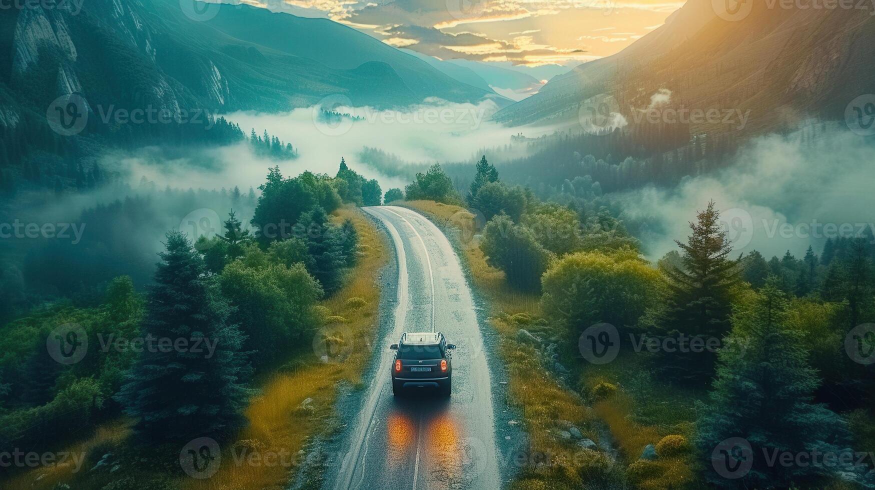 A car driving on a road winding through a lush, green mountain valley at dawn. photo