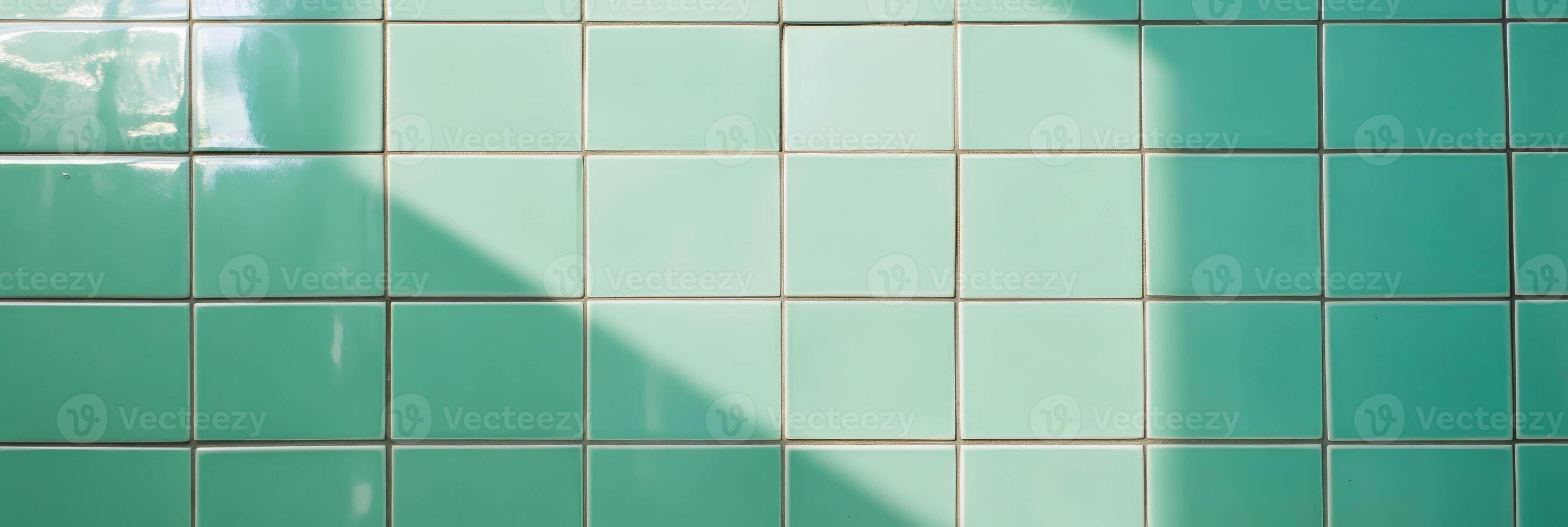 Light green tiled wall texture with clean grout and shadow play photo