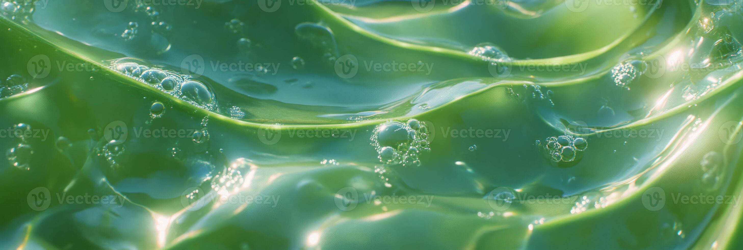Translucent aloe gel texture with air bubbles and light reflections photo