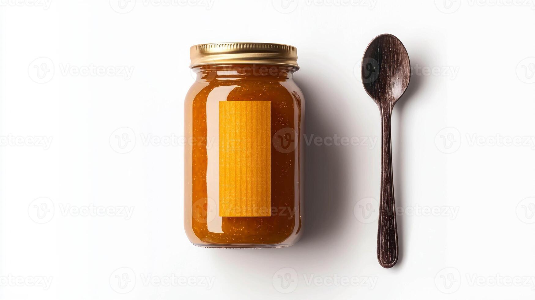 Delicious apricot jam in a glass jar with wooden spoon on white background photo