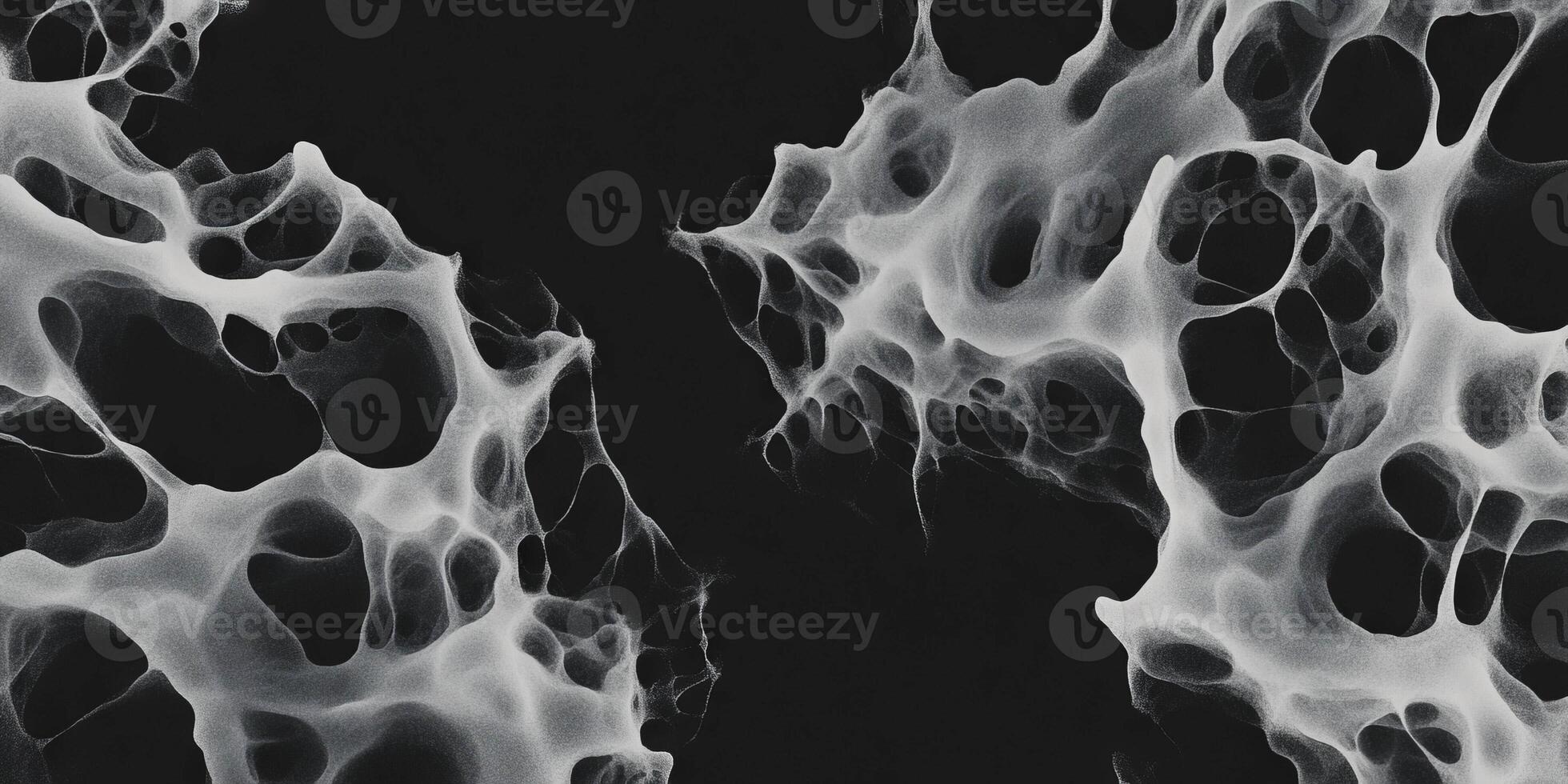 Mottled grayscale texture with sharp edges and deep shadows on a black background photo