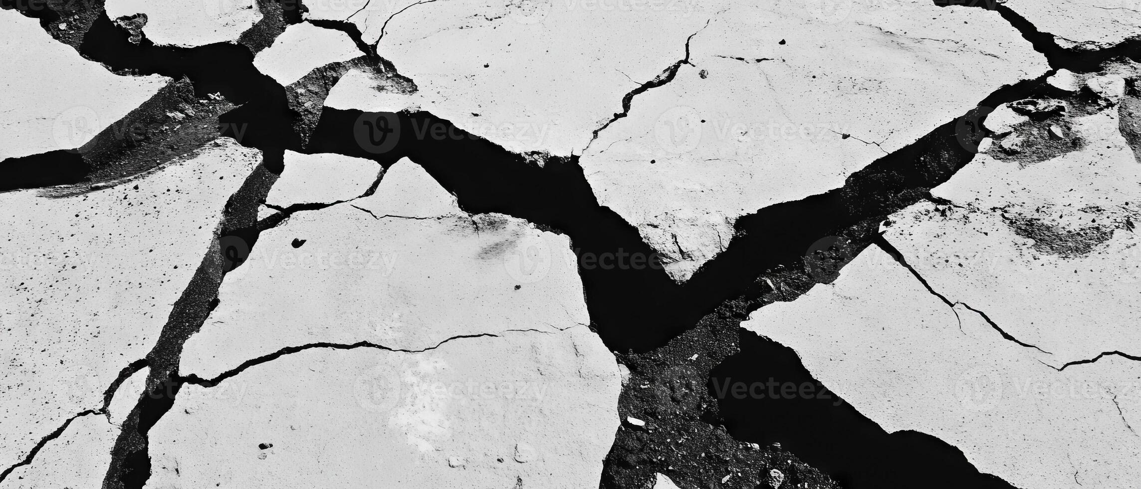 Cracked asphalt surface with irregular black and gray textures showcasing weathering effects photo
