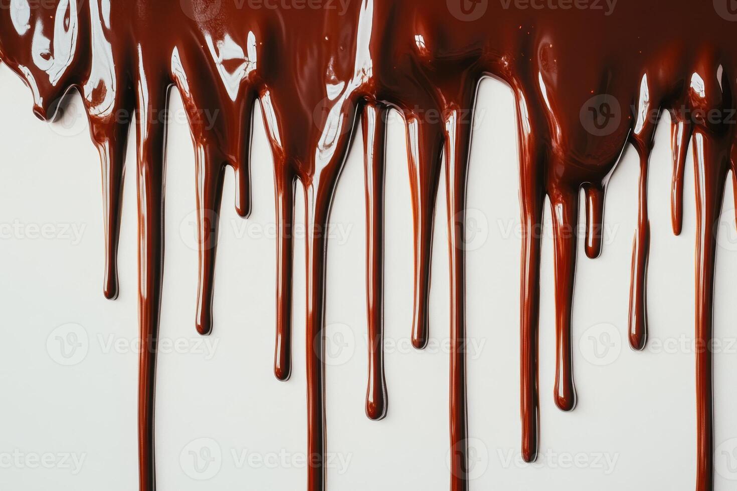 A close up of a chocolate drip on a white surface photo