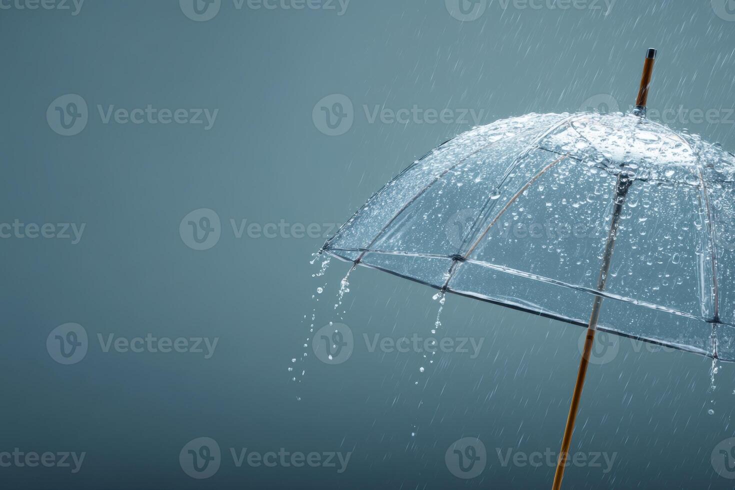An umbrella is being held up in the rain photo