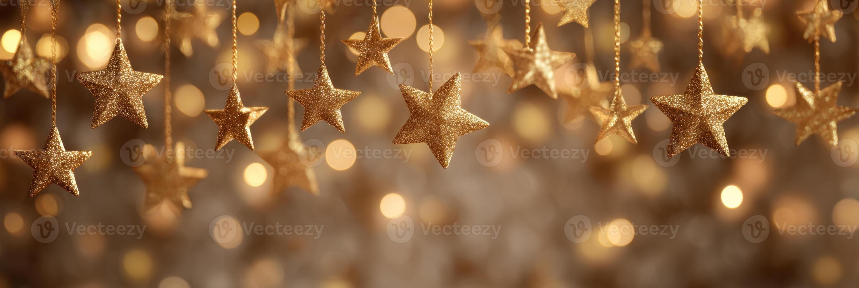 Golden christmas stars hanging from strings photo